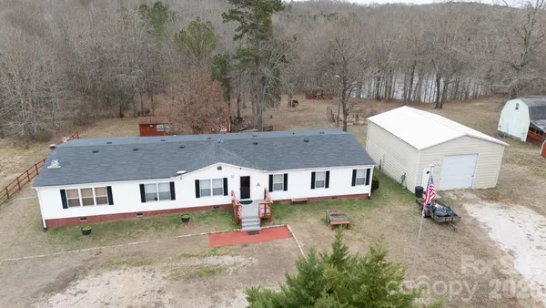 an aerial view of a house with a yard