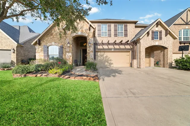 a front view of a house with a yard and porch