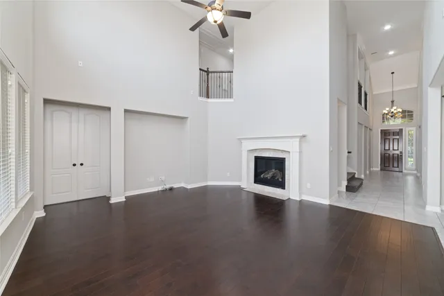 a view of a livingroom with wooden floor a fireplace and window