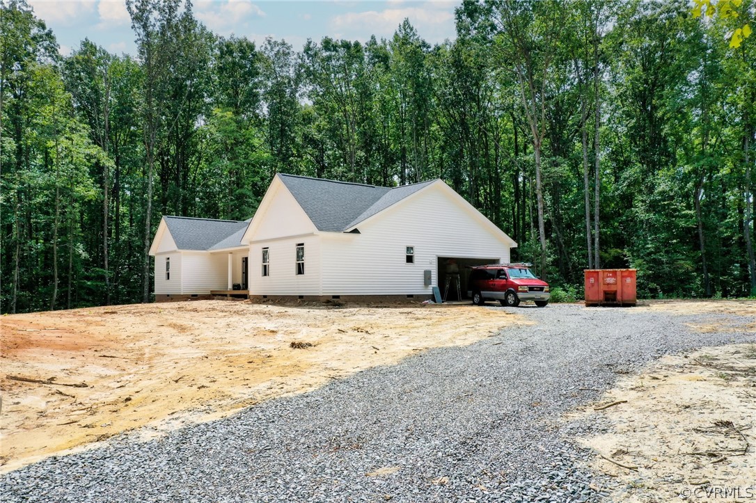 19173 Teman Road Beaverdam, VA 23015 - Photo 2 of 35 a house with a wooden fence and trees