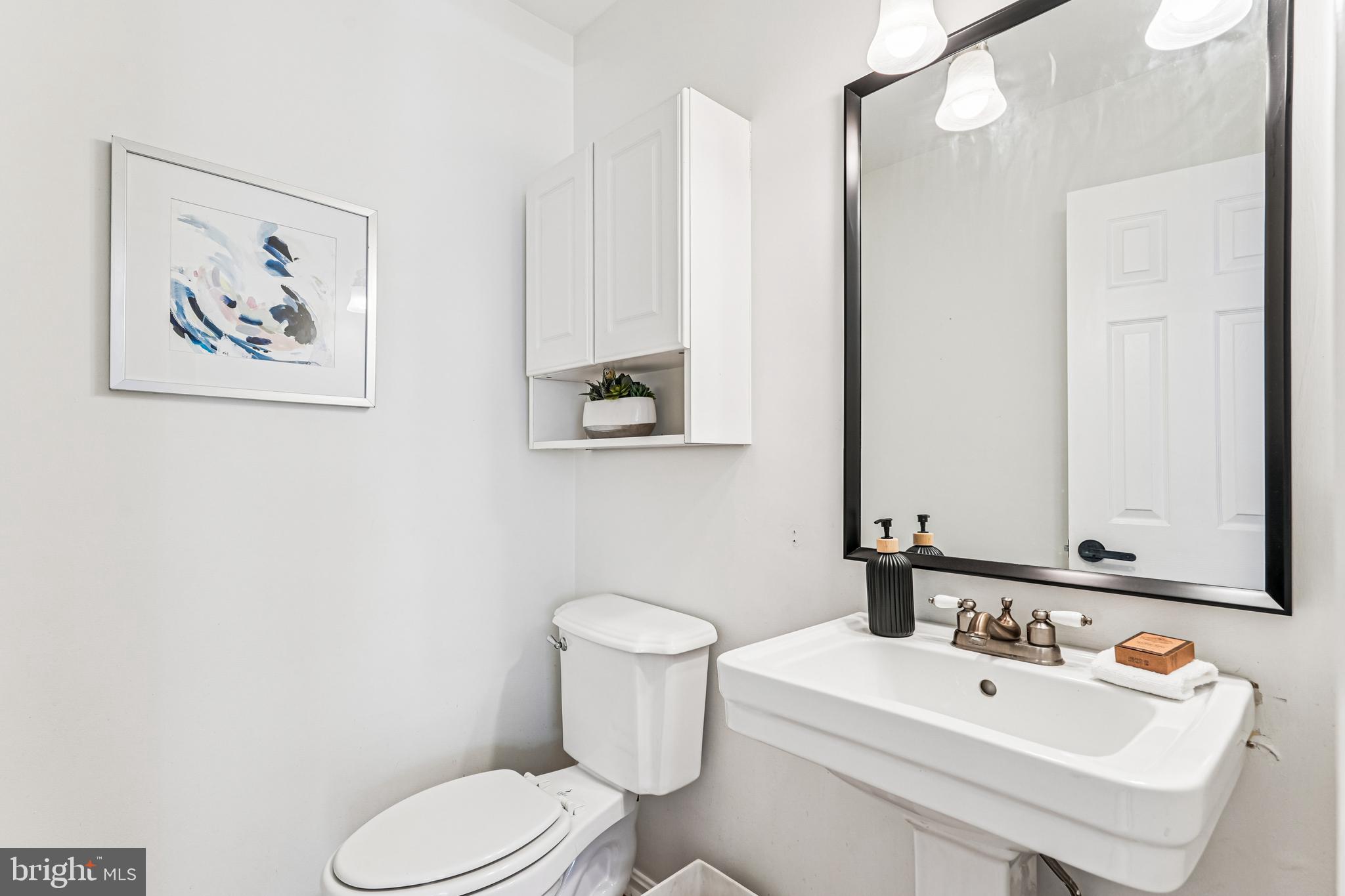 120 Ridgepoint Place Gaithersburg, MD 20878 - Photo 14 of 51 a bathroom with a toilet sink and mirror