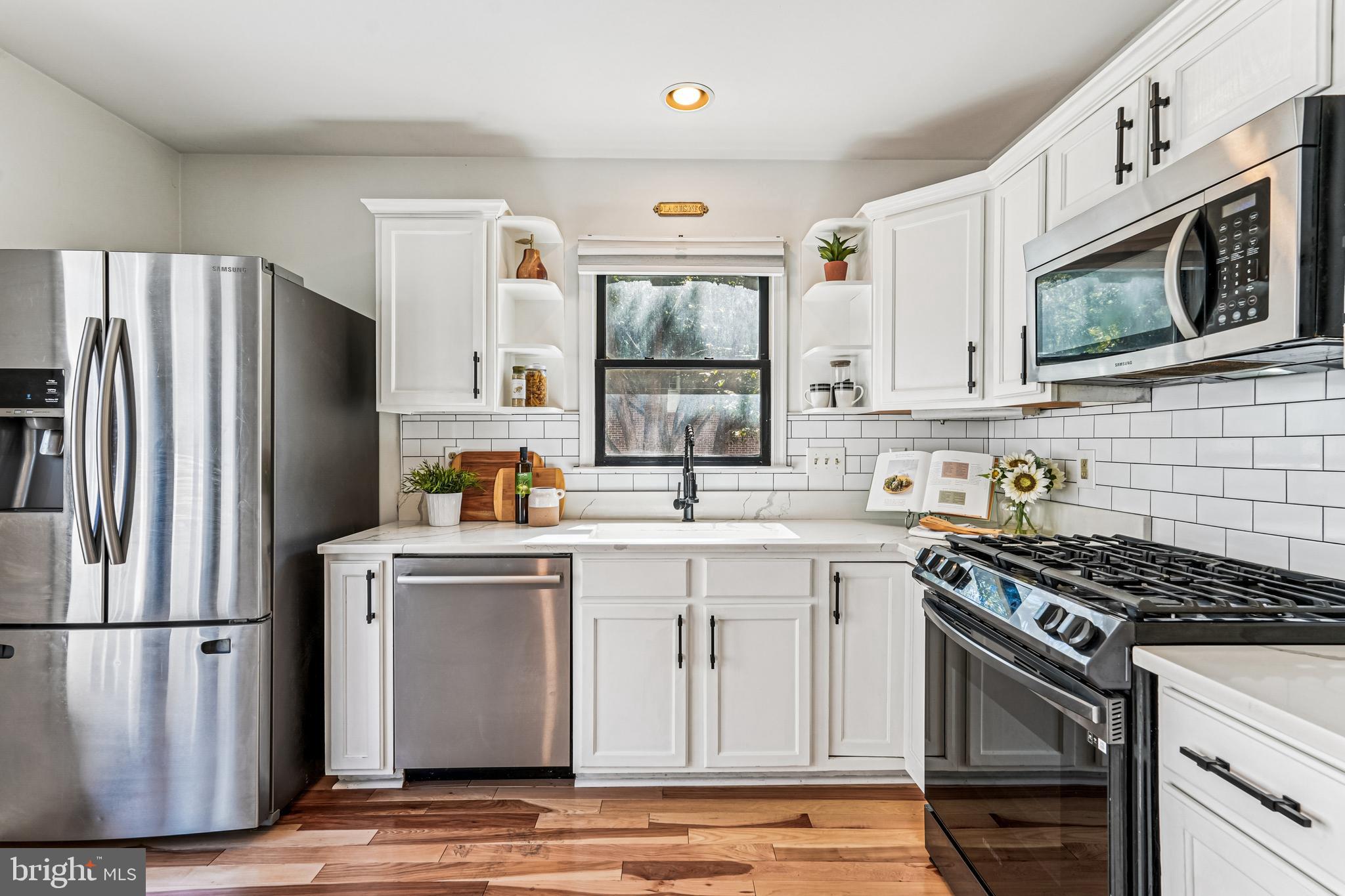 120 Ridgepoint Place Gaithersburg, MD 20878 - Photo 5 of 51 a kitchen with stainless steel appliances a stove microwave and a refrigerator