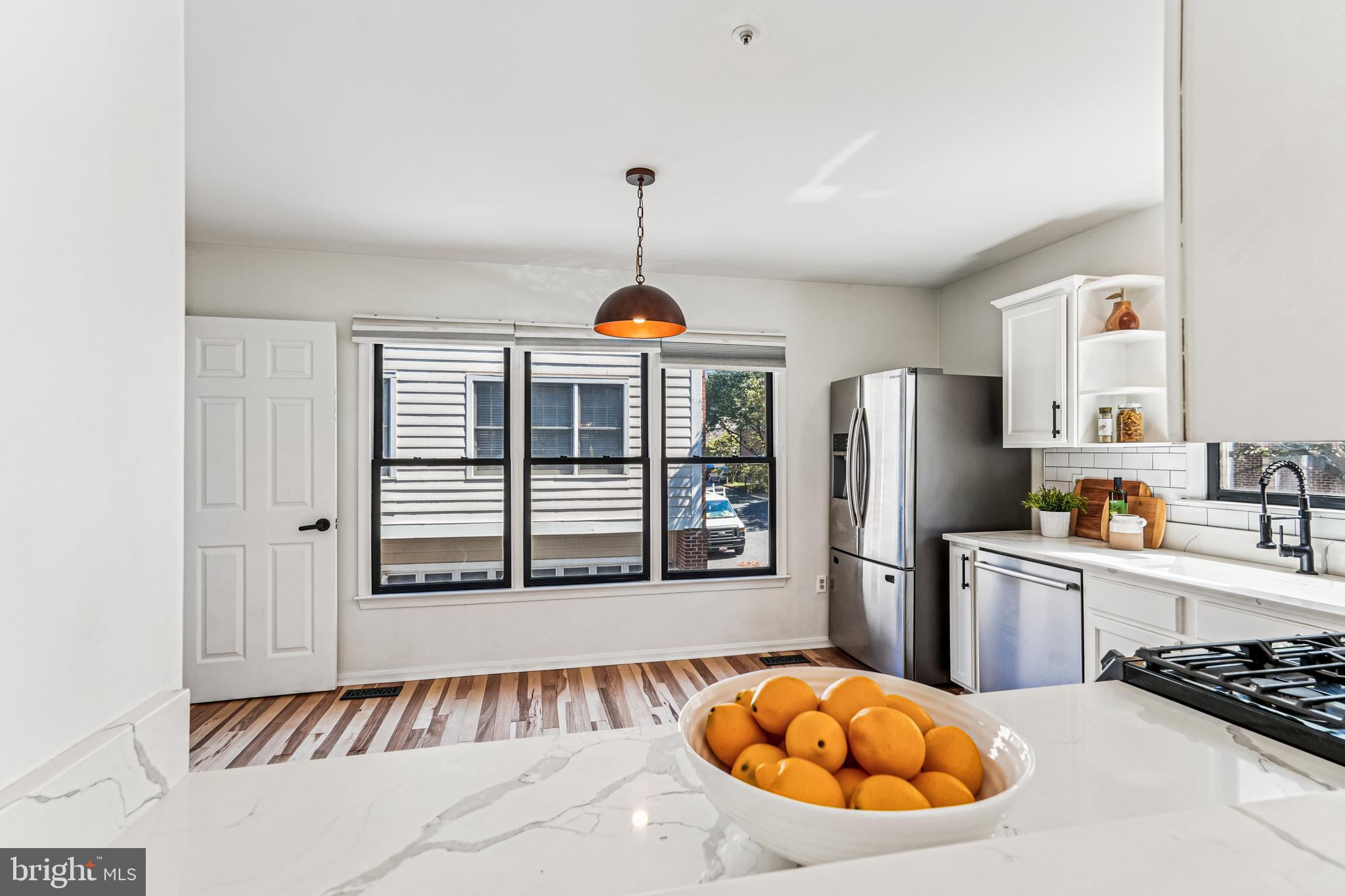 120 Ridgepoint Place Gaithersburg, MD 20878 - Photo 7 of 51 a kitchen with stainless steel appliances granite countertop a stove a refrigerator a sink dishwasher with a dining table and chair