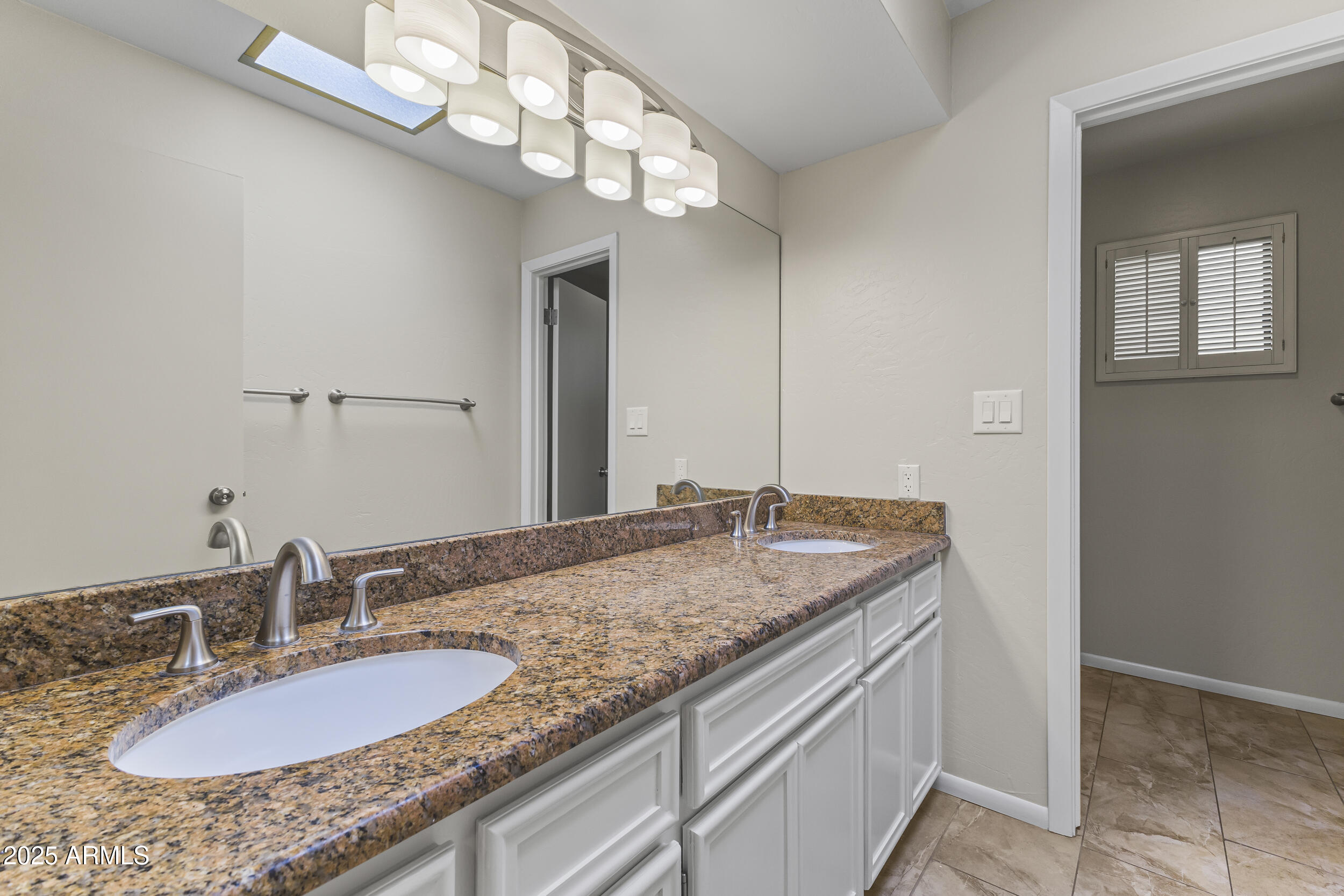 6835 North 1st Place Phoenix, AZ 85012 - Photo 14 of 42 a bathroom with a granite countertop double vanity and a mirror