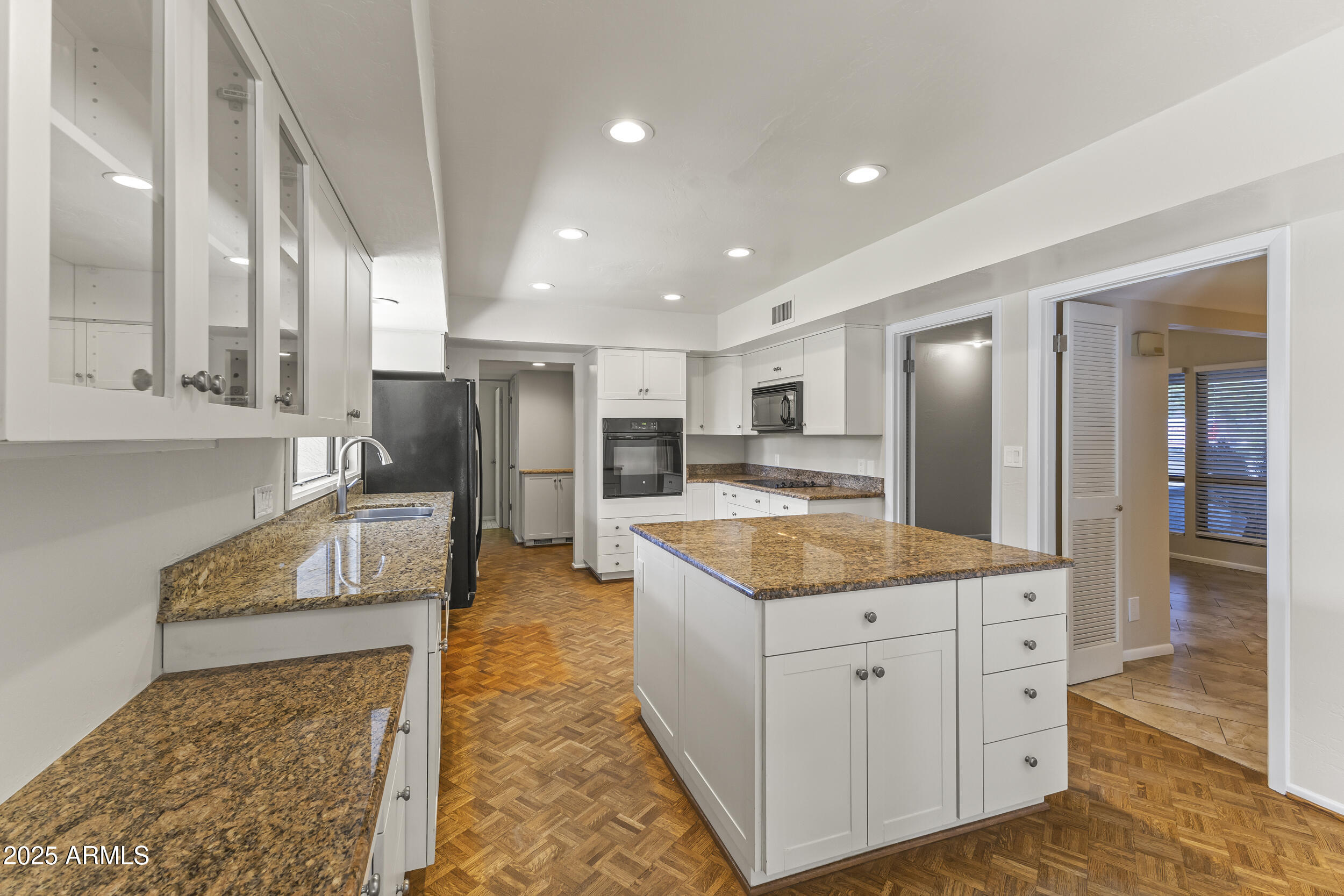 6835 North 1st Place Phoenix, AZ 85012 - Photo 17 of 42 a kitchen with stainless steel appliances granite countertop a refrigerator and a stove