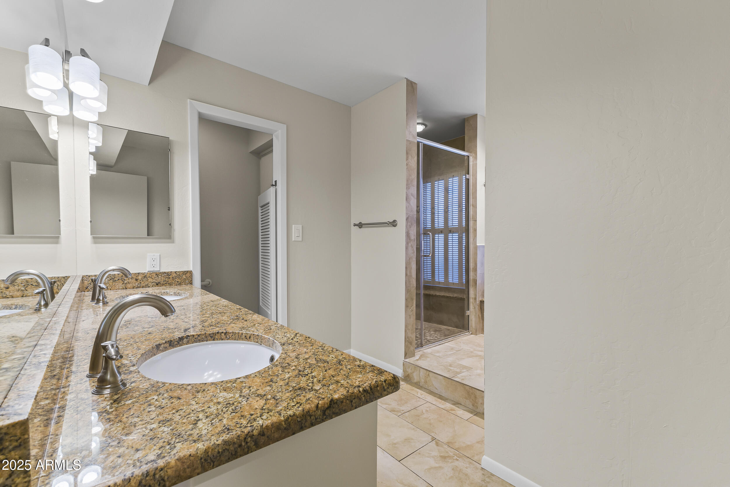 6835 North 1st Place Phoenix, AZ 85012 - Photo 28 of 42 a bathroom with a granite countertop sink and a mirror