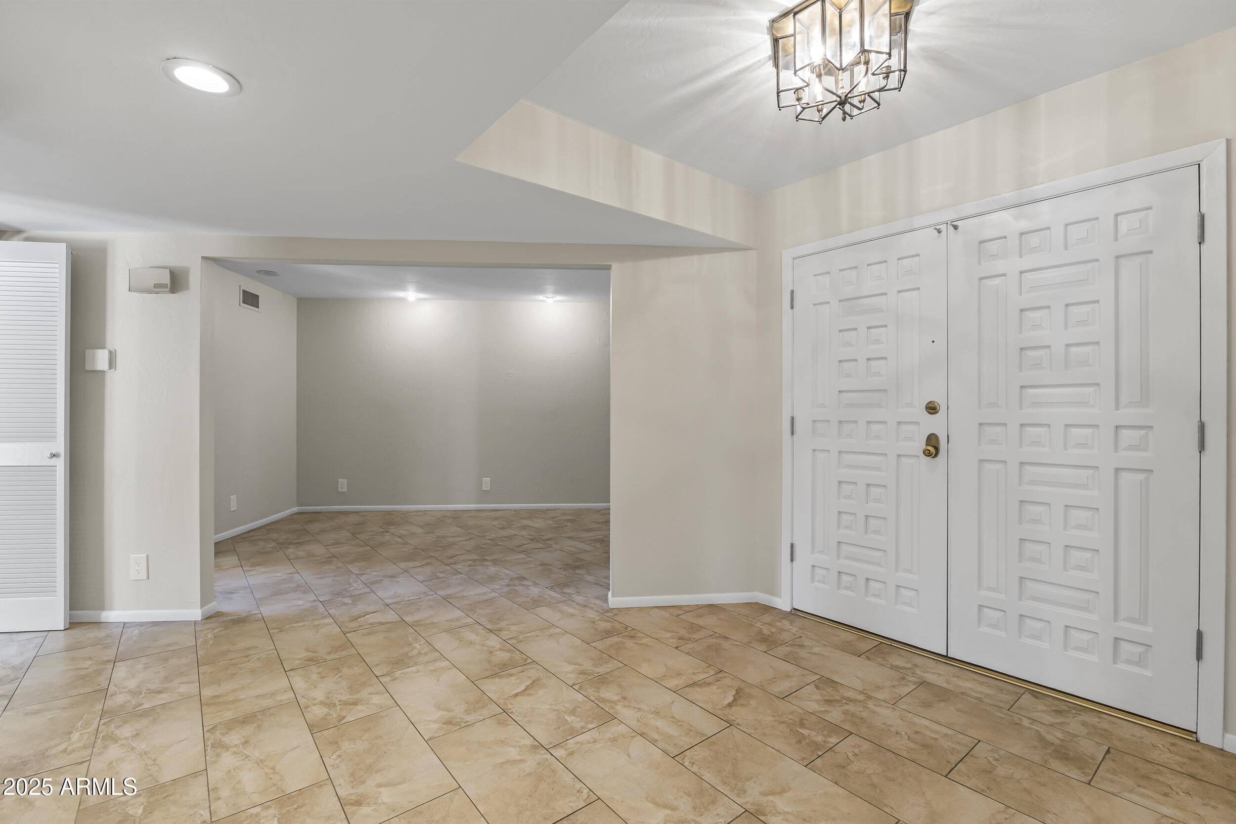 6835 North 1st Place Phoenix, AZ 85012 - Photo 33 of 42 an empty room with chandelier fan