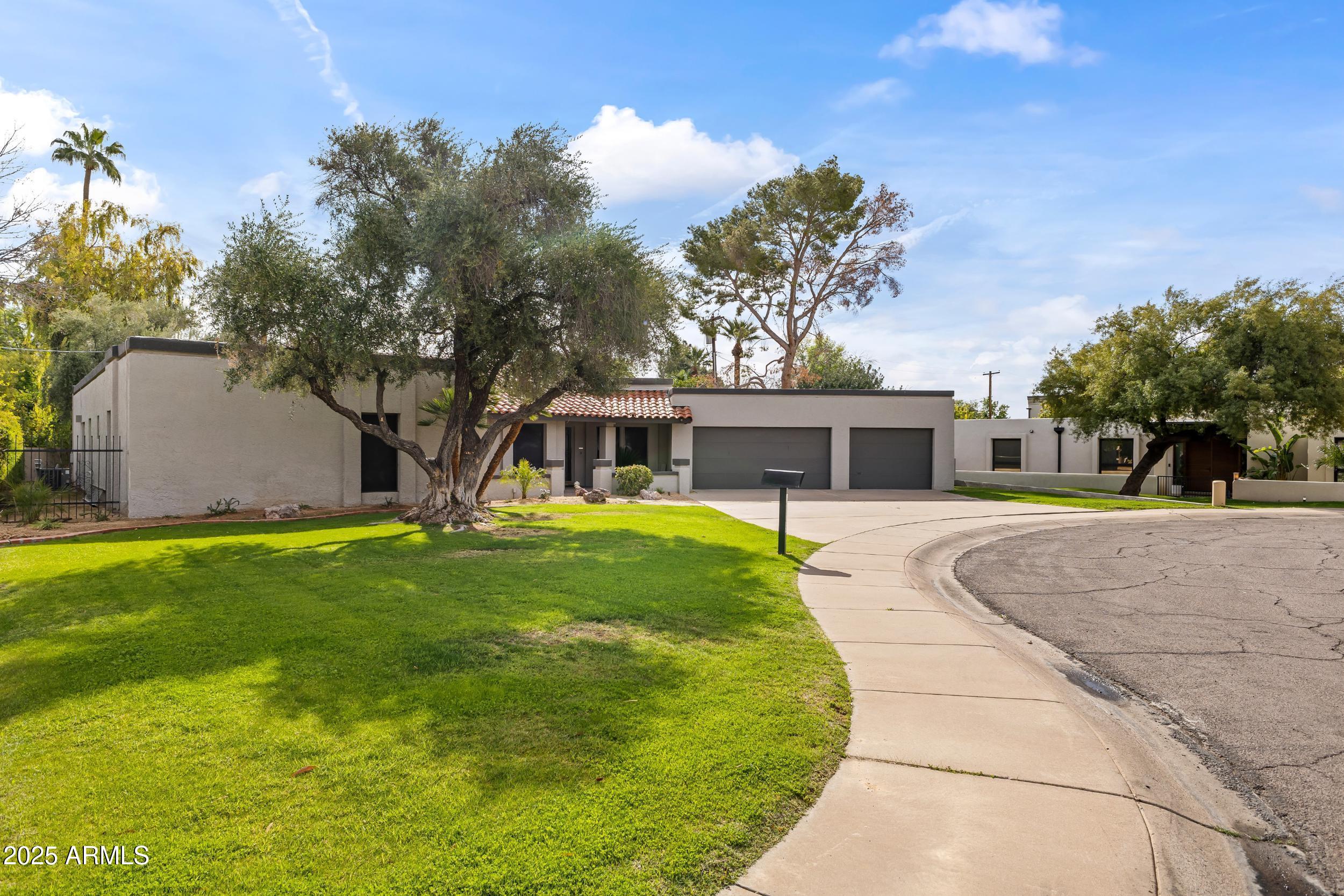6835 North 1st Place Phoenix, AZ 85012 - Photo 41 of 42 a front view of a house with a yard and trees