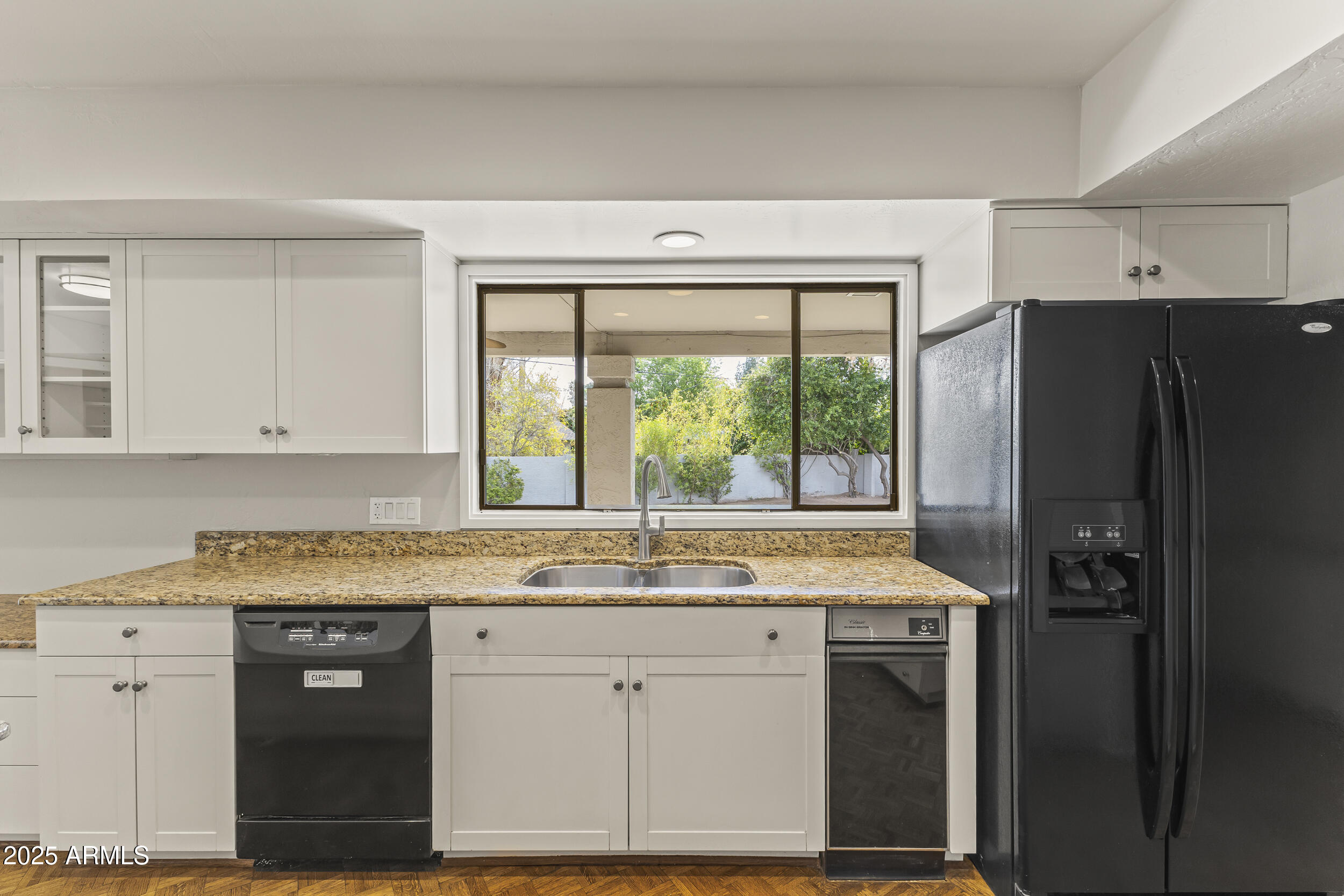 6835 North 1st Place Phoenix, AZ 85012 - Photo 6 of 42 a kitchen with a granite countertop cabinets and a refrigerator