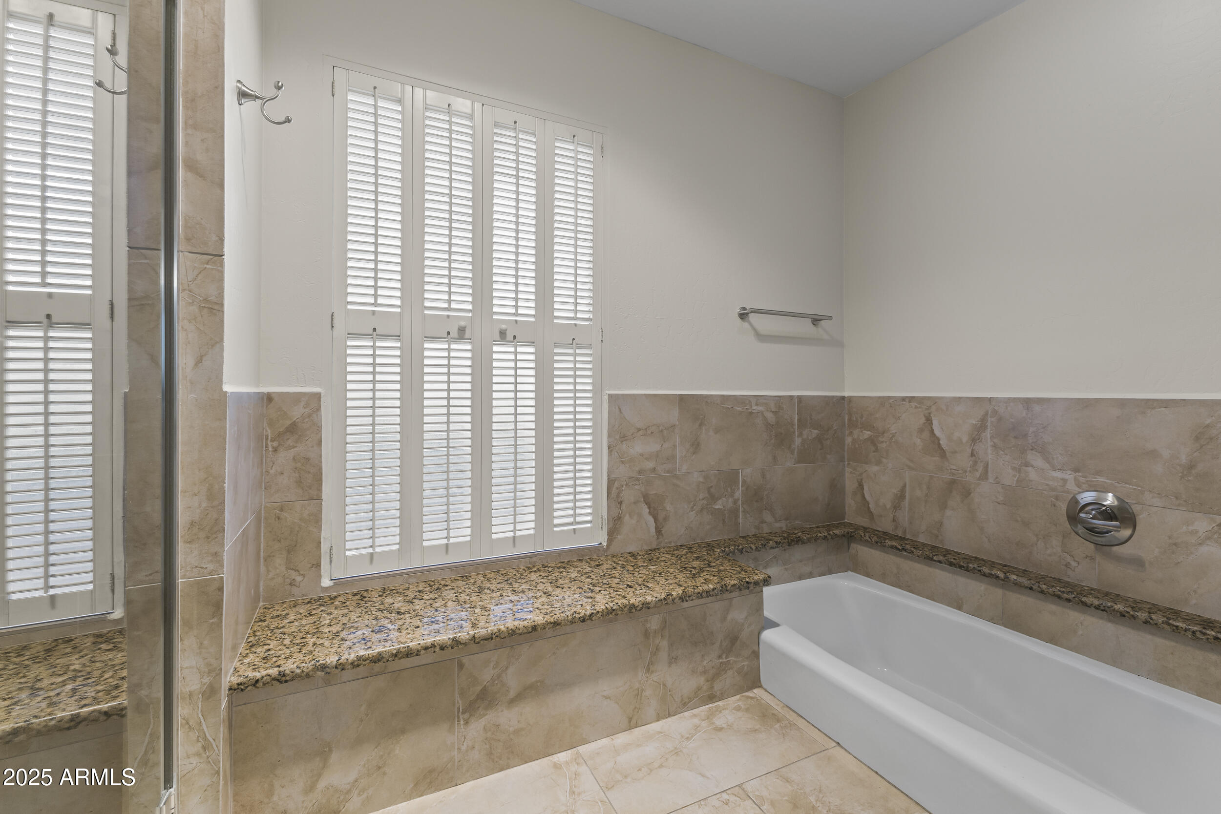 6835 North 1st Place Phoenix, AZ 85012 - Photo 10 of 42 a bathroom with a bathtub and window