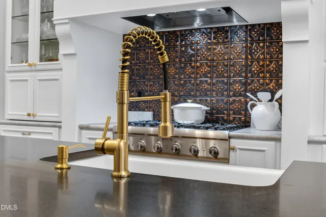 a living room with furniture a fireplace and a chandelier