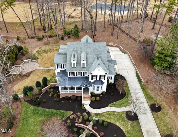 an aerial view of a house with swimming pool garden and patio