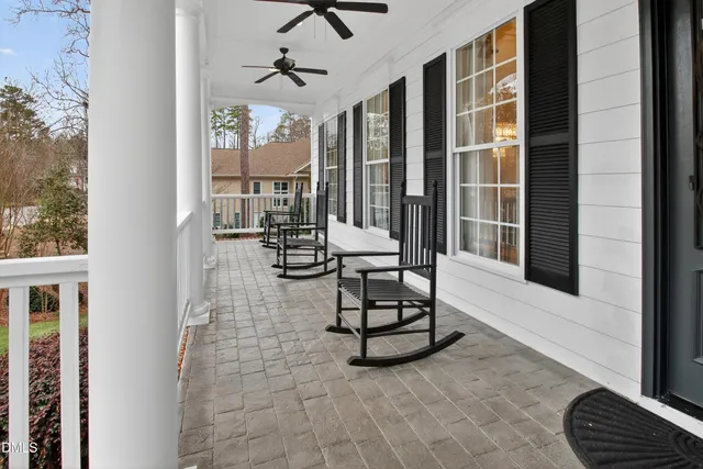a kitchen with kitchen island granite countertop a stove a oven a sink and a dining table with wooden floor
