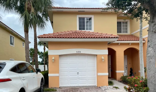 a front view of a house with garage