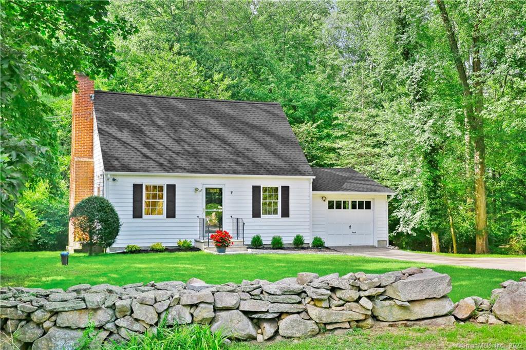 96 Pond Road Wilton, CT 06897 - Photo 1 of 1 a front view of a house with garden