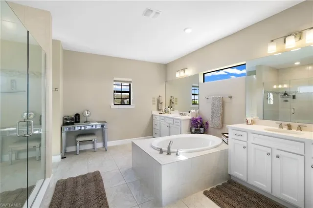 a spacious bathroom with a sink a mirror and a bathtub