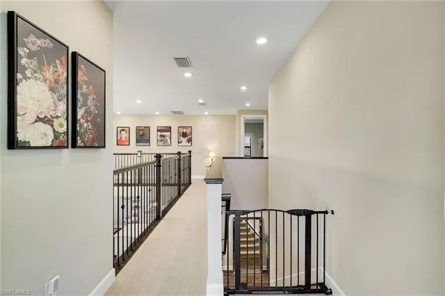 a living room with a bed furniture and a flat tv screen