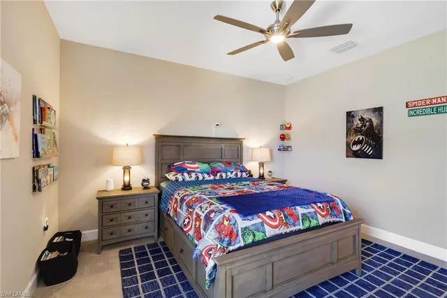 a en suite bathroom with a granite countertop sink and a mirror