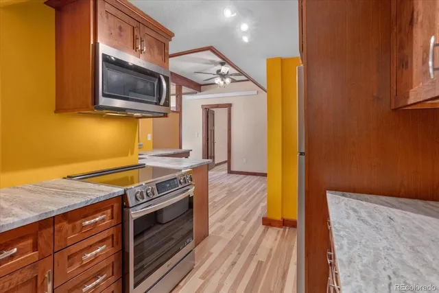 a kitchen with stainless steel appliances granite countertop a stove and a microwave