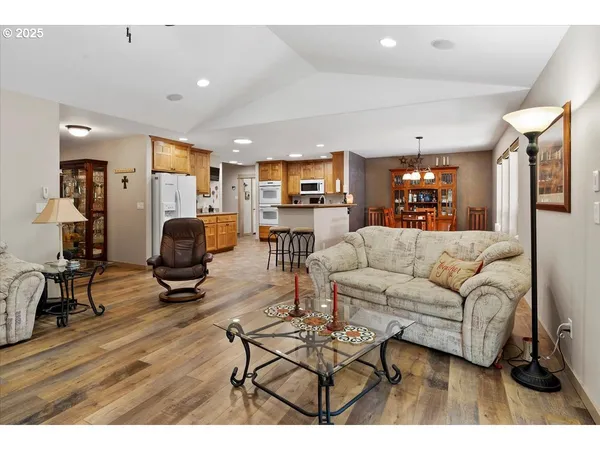 a living room with furniture a wooden floor and a flat screen tv