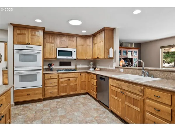 a kitchen with granite countertop a stove microwave and sink