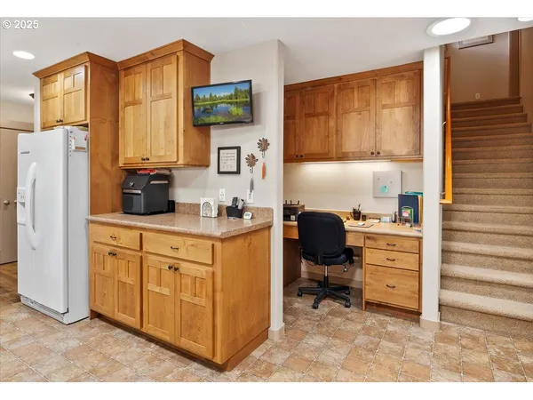 a kitchen with a refrigerator and cabinets