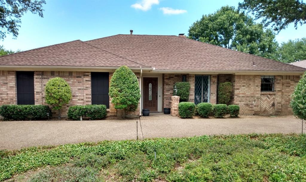 2409 Glen Morris Road Carrollton, TX 75007 - Photo 1 of 1 a front view of a house with a yard and potted plants