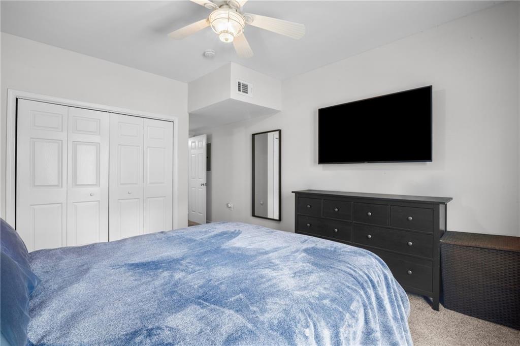 3675 Peachtree Road Northeast, Unit 45 Atlanta, GA 30319 - Photo 19 of 42 a bedroom with a bed and a flat screen tv