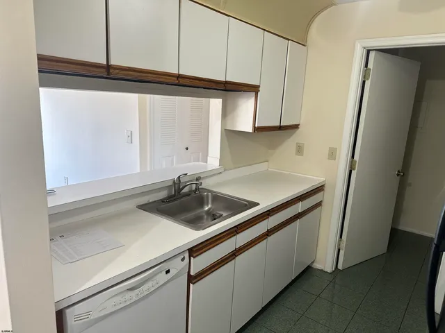 a kitchen with a sink and a refrigerator