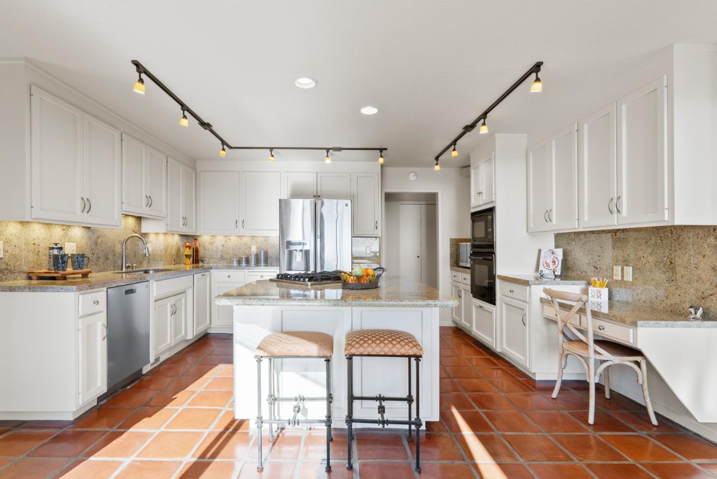 925 Skyward Drive Aptos, CA 95003 - Photo 18 of 95 a kitchen with refrigerator cabinets dining table and chairs
