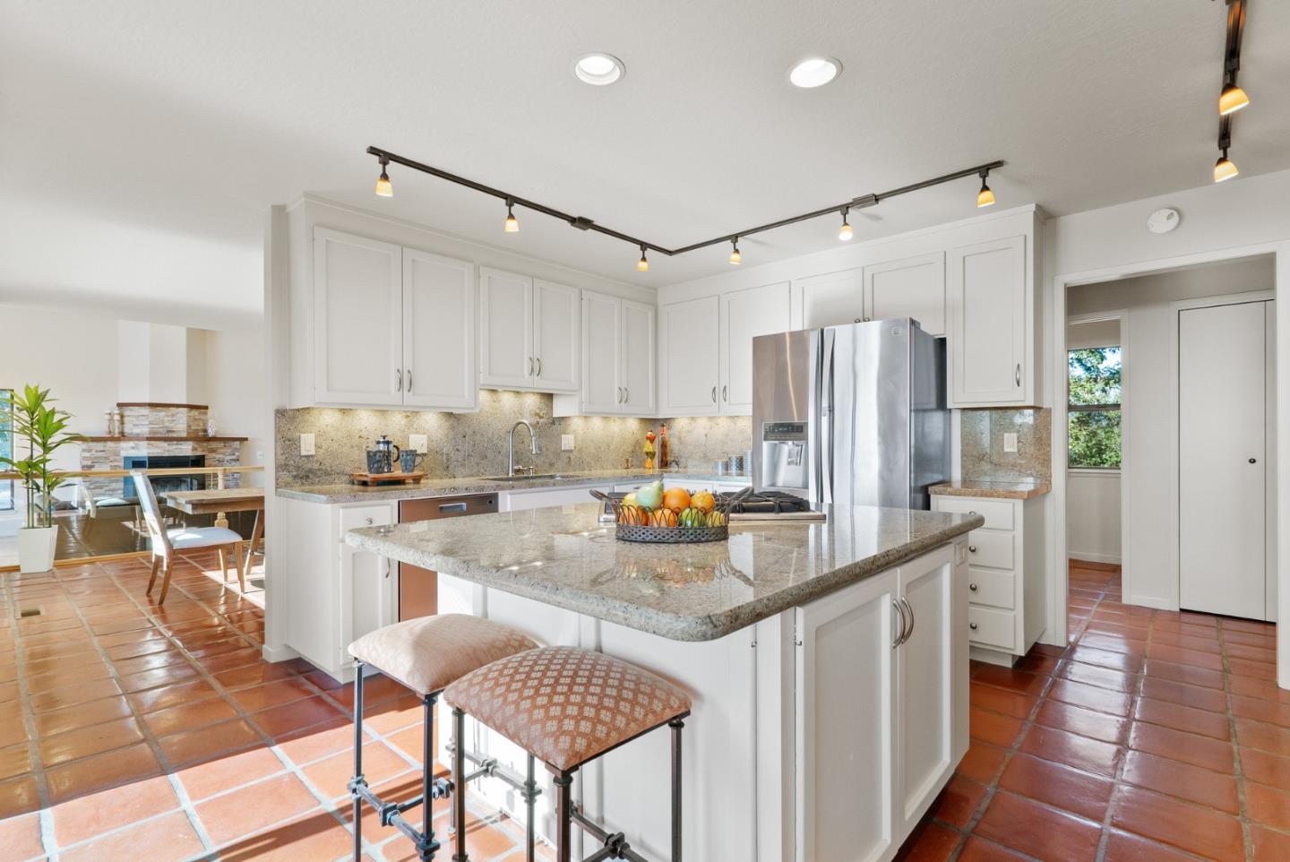 925 Skyward Drive Aptos, CA 95003 - Photo 19 of 95 a kitchen with refrigerator and chairs