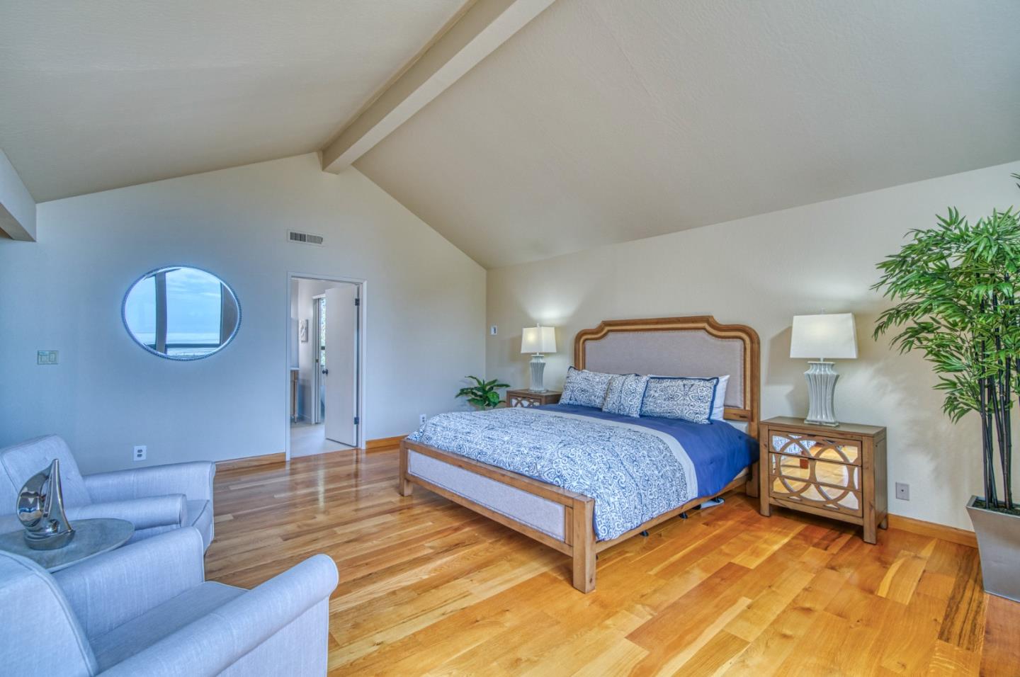 925 Skyward Drive Aptos, CA 95003 - Photo 53 of 95 a spacious bedroom with a bed and a potted plant