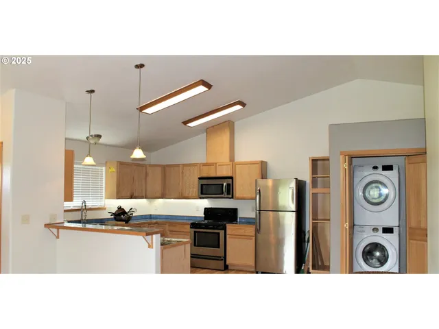 a kitchen with granite countertop a refrigerator and a sink