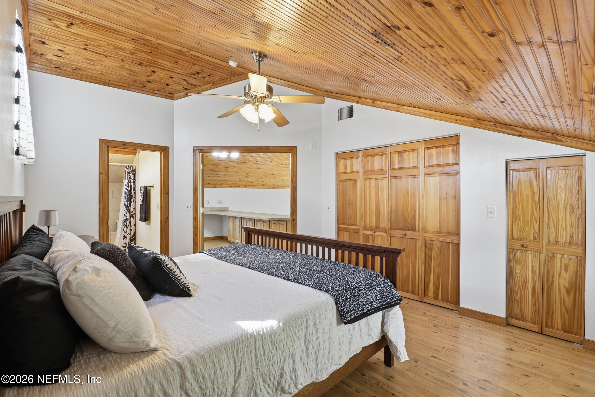 5714 Southeast 4th Avenue Keystone Heights, FL 32656 - Photo 27 of 53 a bedroom with a large bed and a chandelier