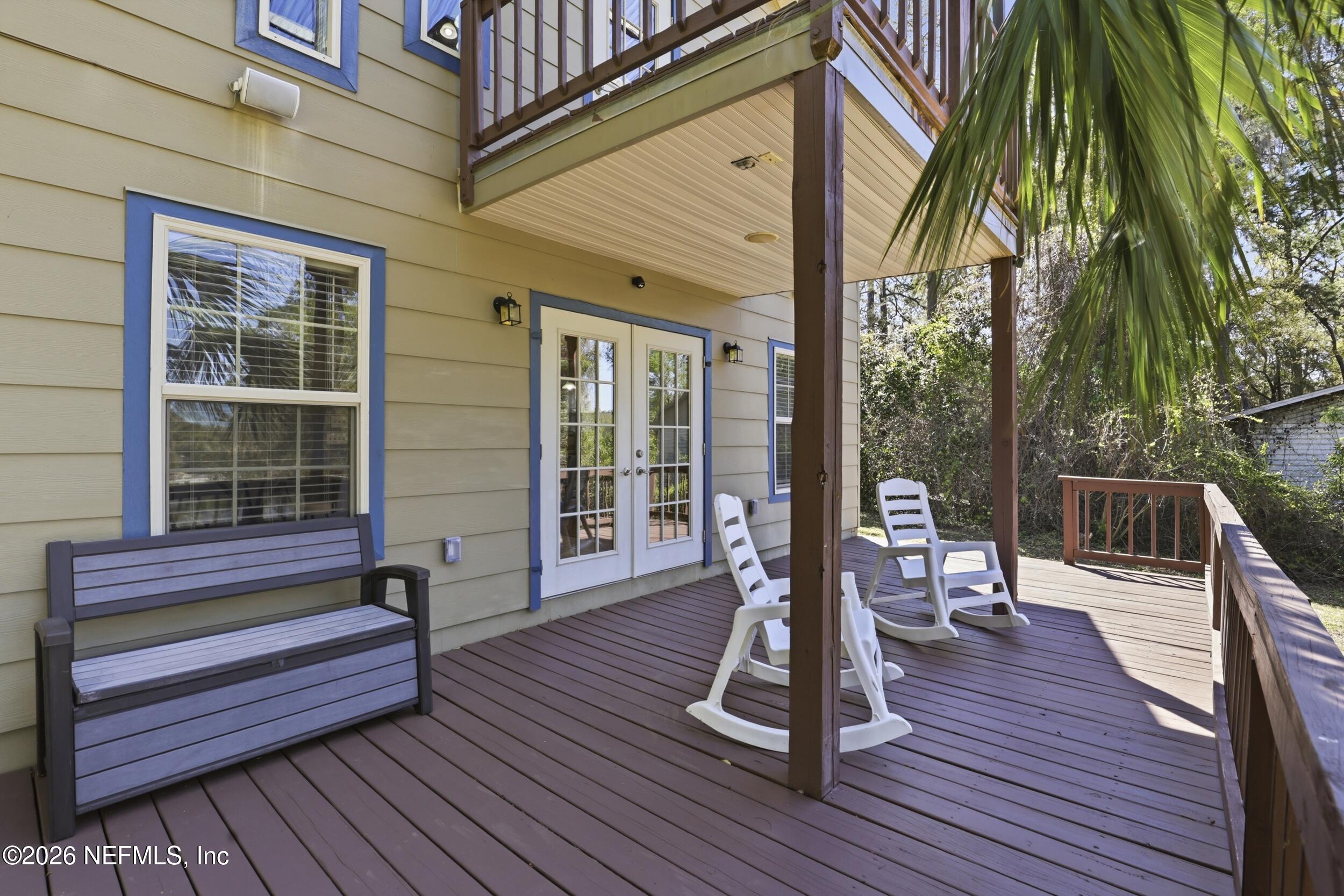 5714 Southeast 4th Avenue Keystone Heights, FL 32656 - Photo 33 of 53 a balcony with wooden floor table and chairs