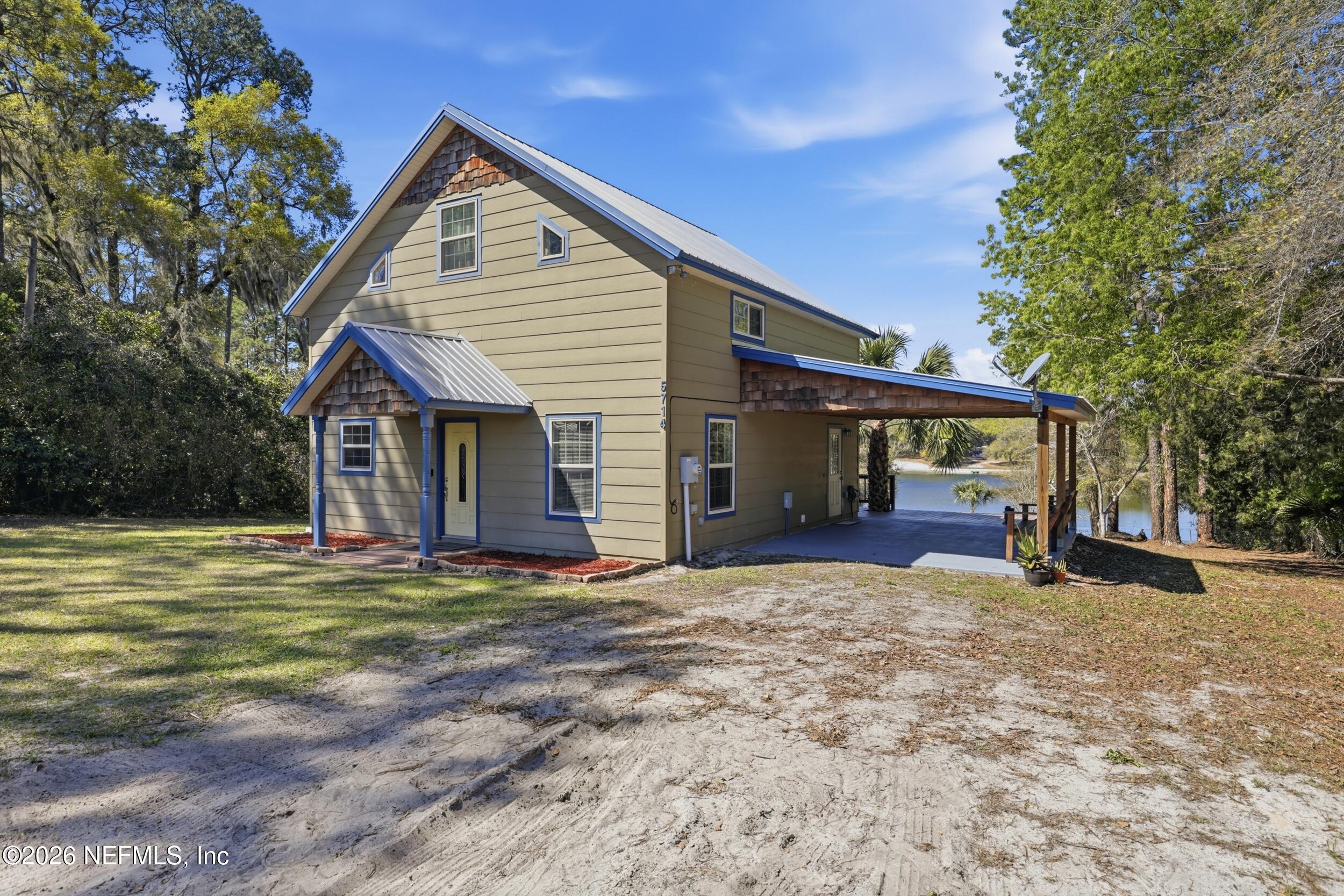 5714 Southeast 4th Avenue Keystone Heights, FL 32656 - Photo 38 of 53 a view of a house with a yard and garage