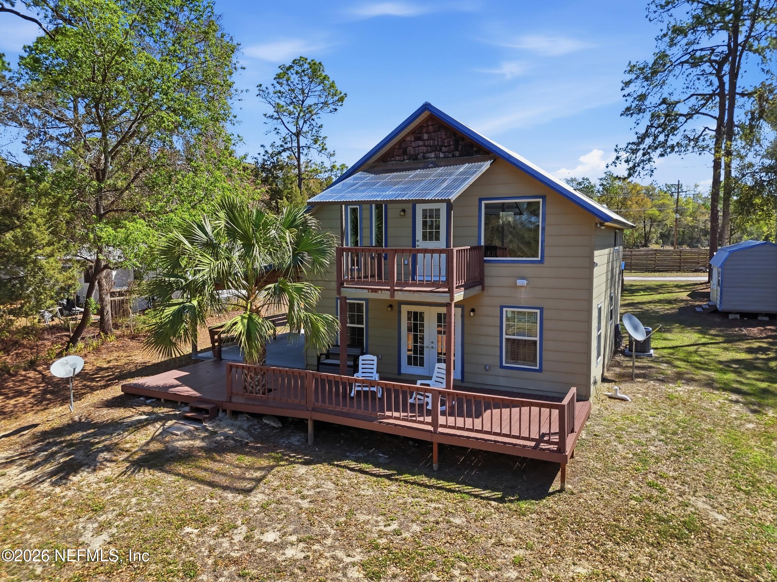 5714 Southeast 4th Avenue Keystone Heights, FL 32656 - Photo 47 of 53 a view of a house with a wooden deck and a yard