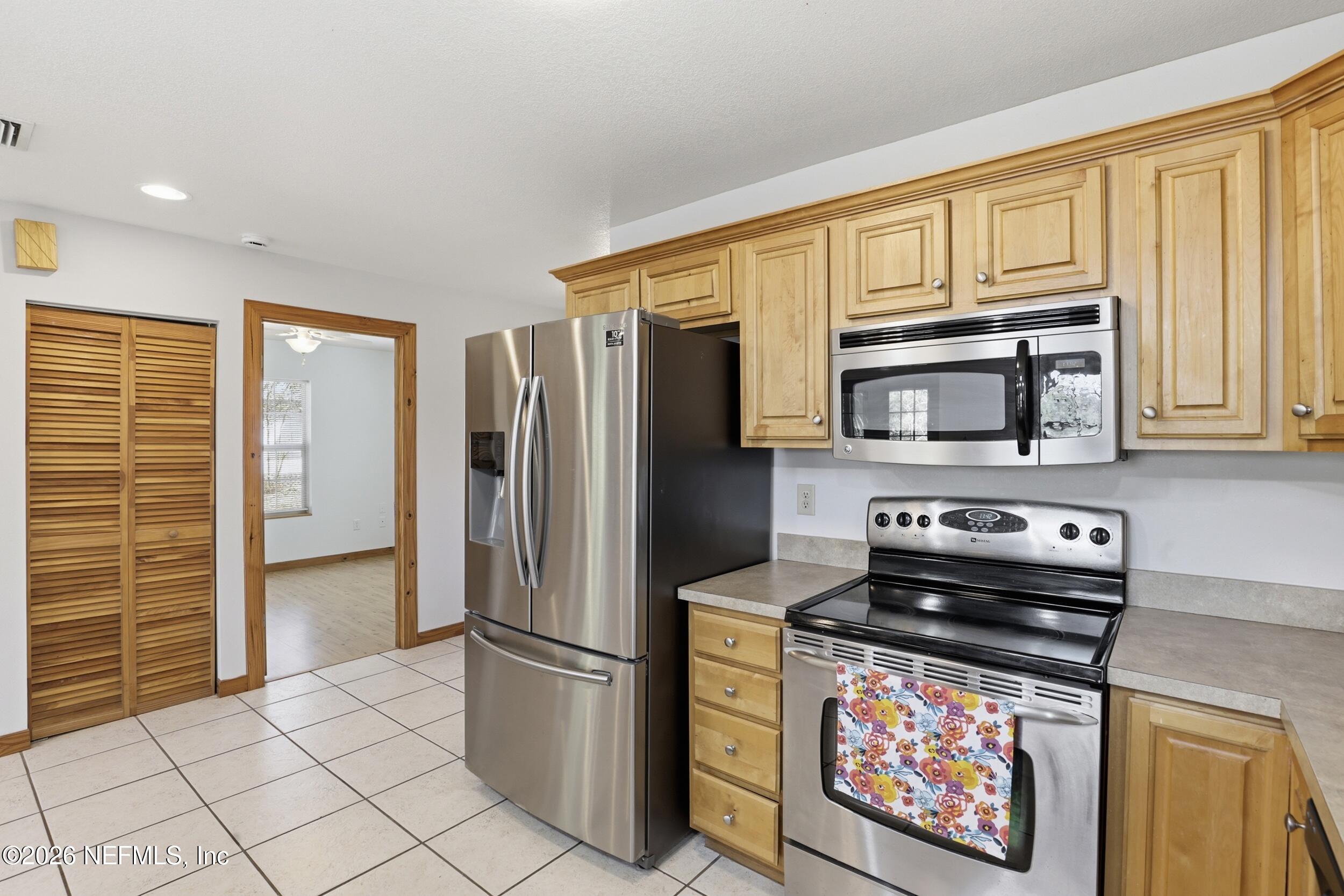 5714 Southeast 4th Avenue Keystone Heights, FL 32656 - Photo 8 of 53 a kitchen with stainless steel appliances granite countertop a refrigerator stove and cabinets