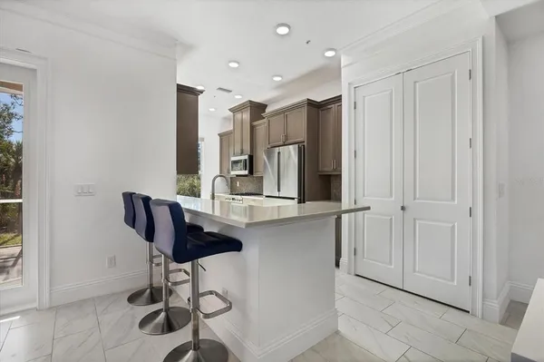 a bathroom with a granite countertop sink a mirror and a bathtub