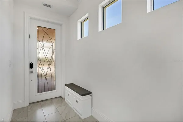 a view of an entryway with wooden floor
