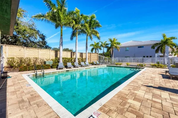 a swimming pool with a lounge chairs