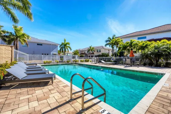 a backyard of a house with barbeque oven table and chairs