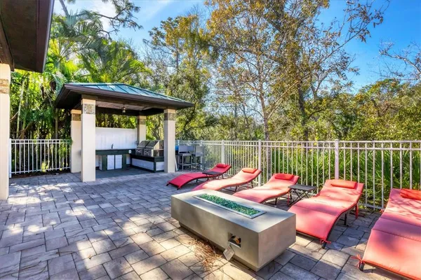 a living room with patio furniture and a large window