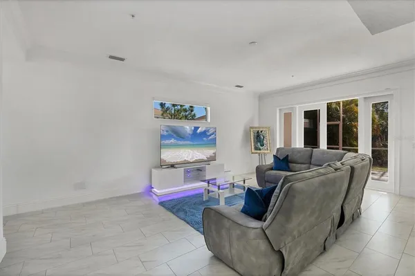 a living room with furniture a large window and a table