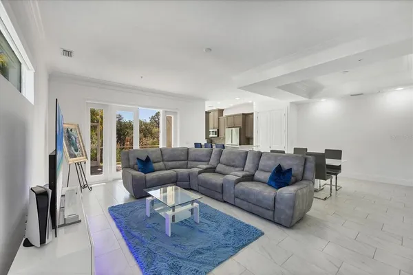 a living room with furniture and wall paintings