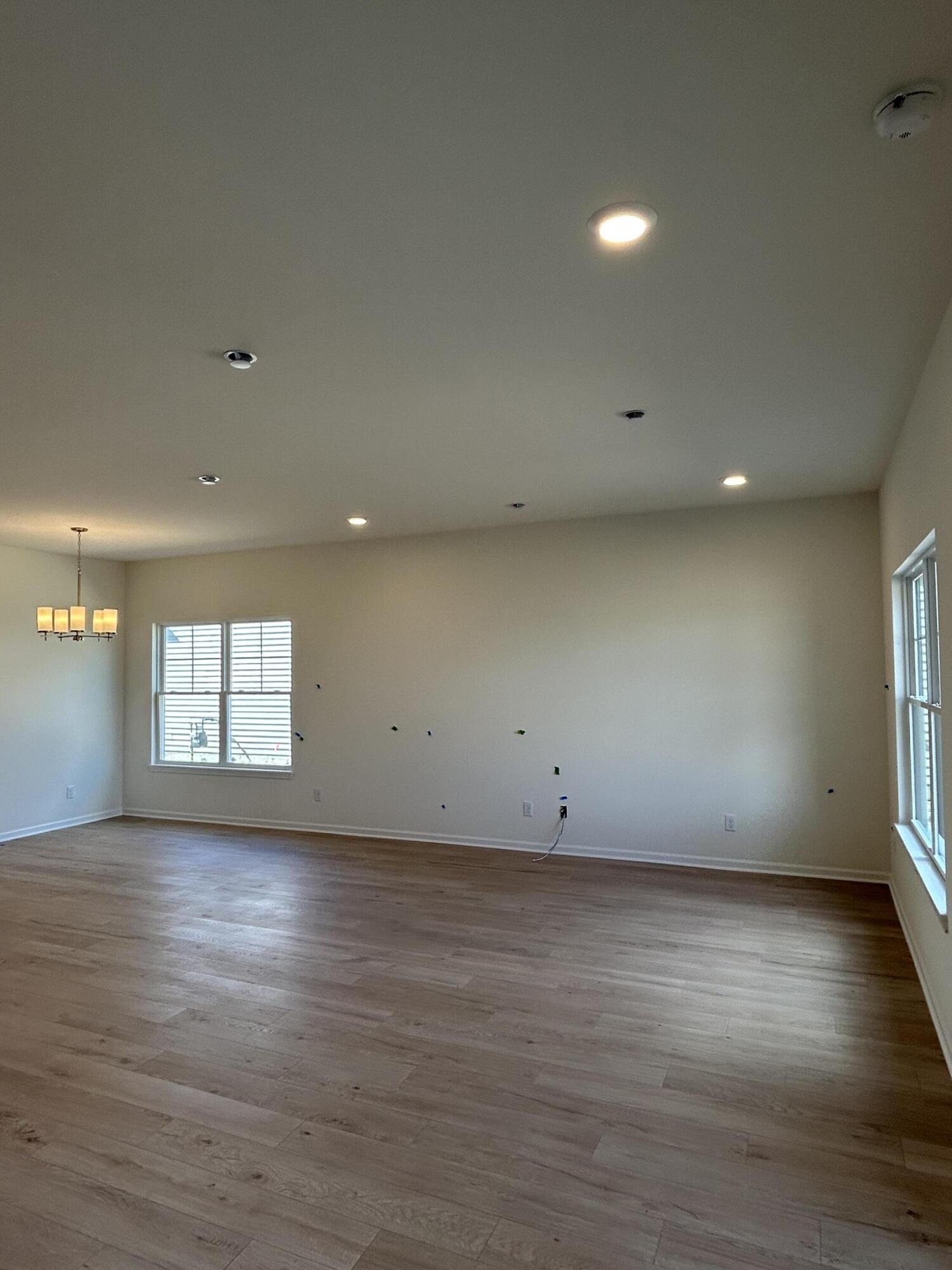 10373 Iowa Street Crown Point, IN 46307 - Photo 4 of 5 an empty room with wooden floor and windows
