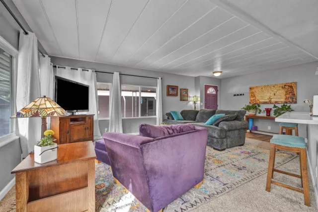 a kitchen with stainless steel appliances kitchen island granite countertop a table chairs sink and cabinets