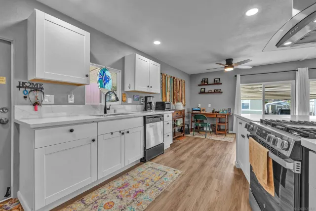 a kitchen with a stove a refrigerator and a fireplace