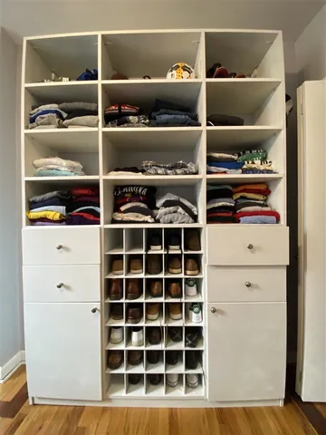 a view of walk in closet with empty racks