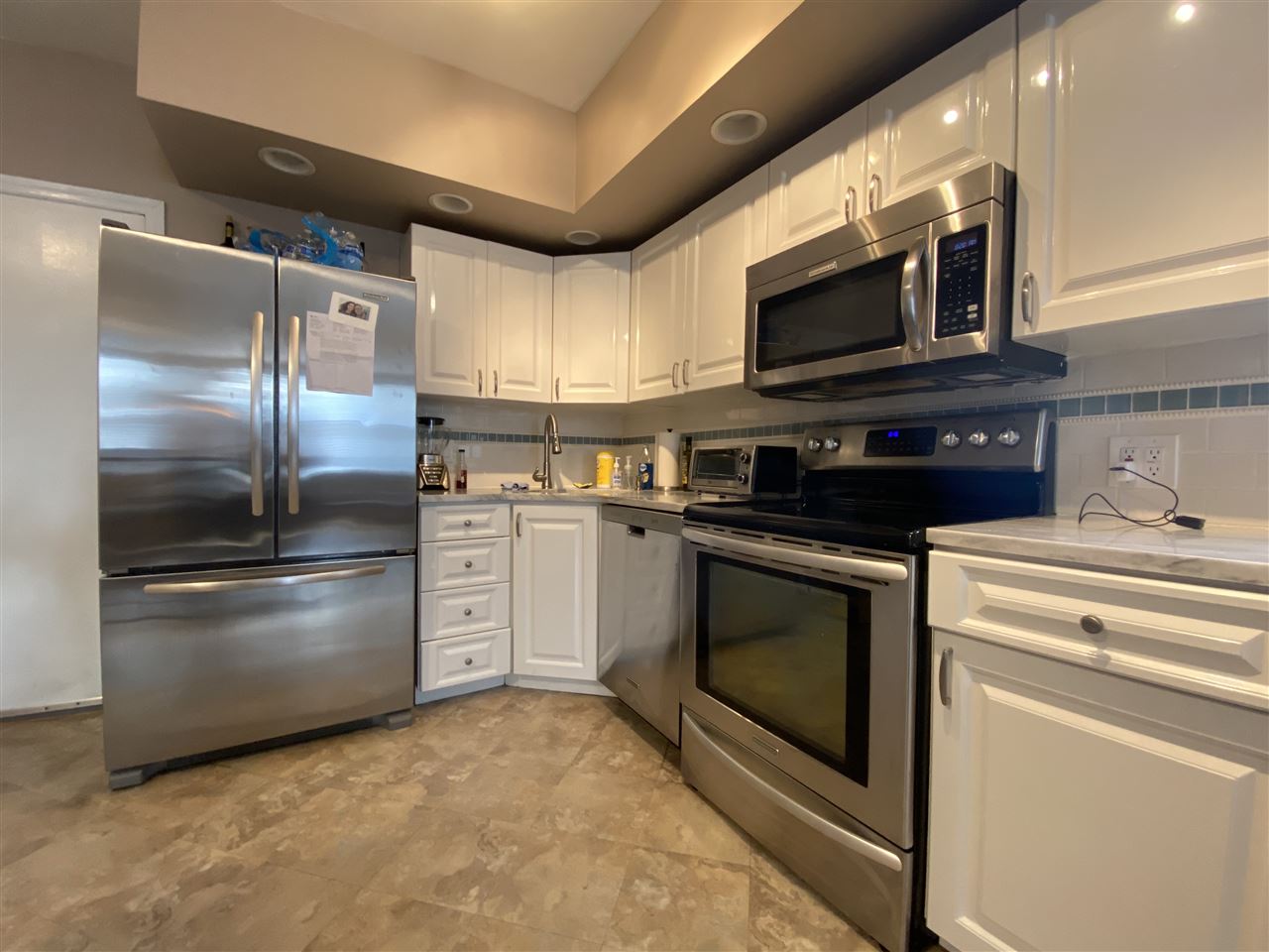 333 Monroe Street, Unit 1A Hoboken, NJ 07030 - Photo 13 of 15 a kitchen with stainless steel appliances a stove a microwave and a refrigerator
